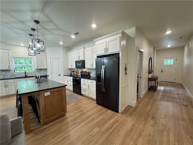 1 Llanon Cir, Bella Vista, AR 72714 - kitchen with black appliances, dark countertops, tasteful backsplash, and recessed lighting