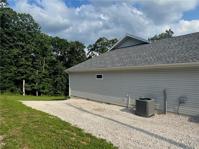 1 Llanon Cir, Bella Vista, AR 72714 - view of home's exterior featuring central AC, roof with shingles, crawl space, and a yard