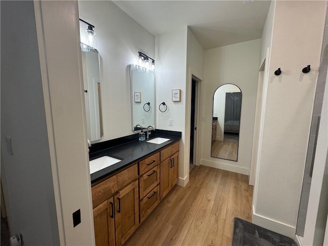 1 Llanon Cir, Bella Vista, AR 72714 - bathroom with wood finished floors, ensuite bathroom, double vanity, and baseboards