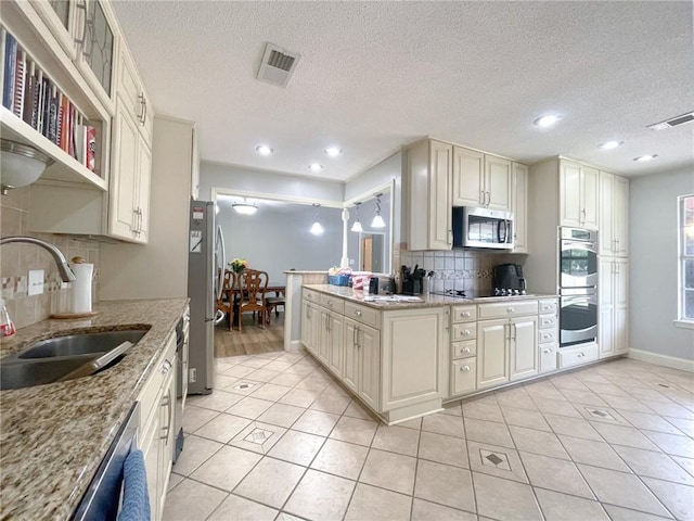 405-407 Rena Rd, Van Buren, AR 72956 - kitchen featuring stainless steel appliances, a sink, backsplash, light tile patterned floors, and baseboards