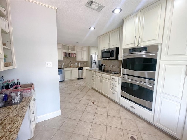 405-407 Rena Rd, Van Buren, AR 72956 - kitchen with stainless steel appliances, a sink, backsplash, light tile patterned floors, and a textured ceiling