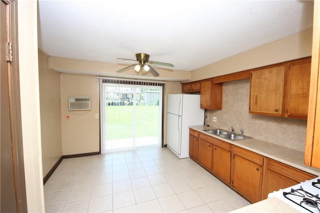1404 W Margaret Pl, Rogers, AR 72756 - kitchen with freestanding refrigerator, a sink, a wall mounted air conditioner, ceiling fan, and light countertops
