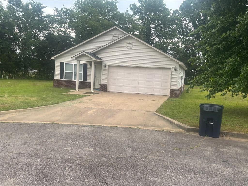9 Cypress Ct, Clarksville, AR 72830 - single story home with a front lawn, an attached garage, driveway, and brick siding