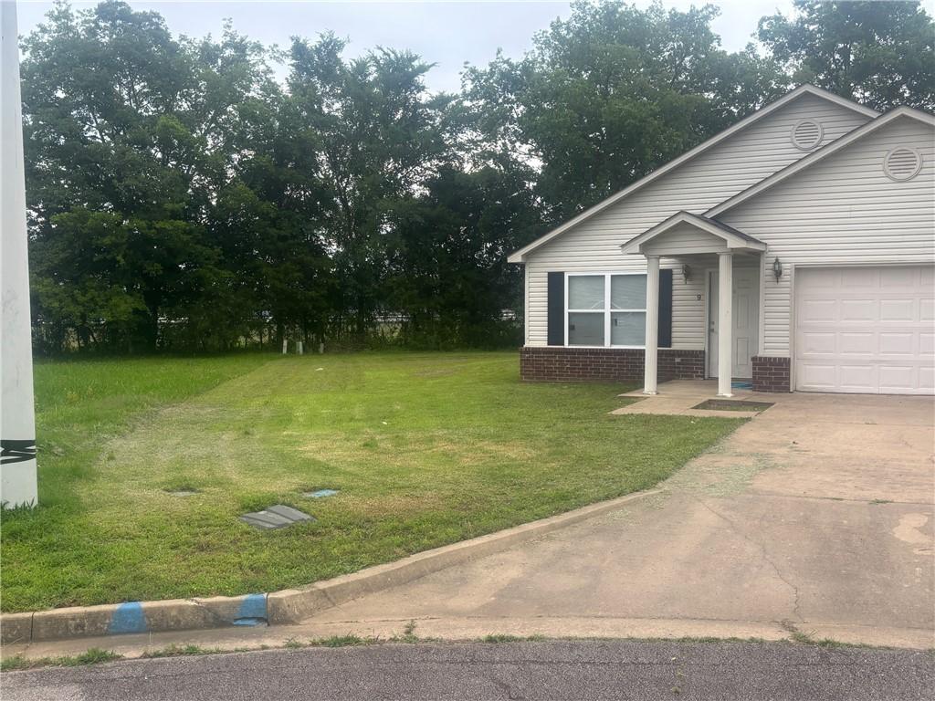 9 Cypress Ct, Clarksville, AR 72830 - view of front of property with a front yard, driveway, and a garage