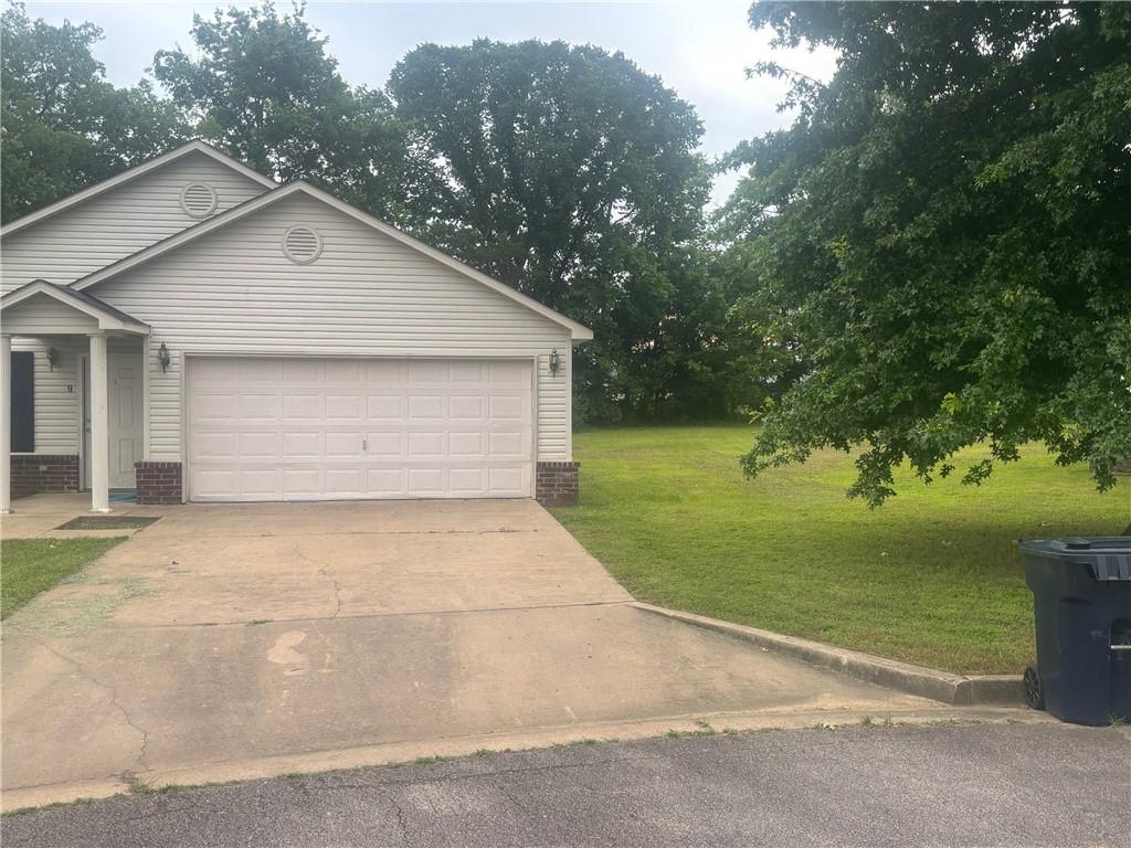 9 Cypress Ct, Clarksville, AR 72830 - view of front of home with concrete driveway, a front yard, and a garage