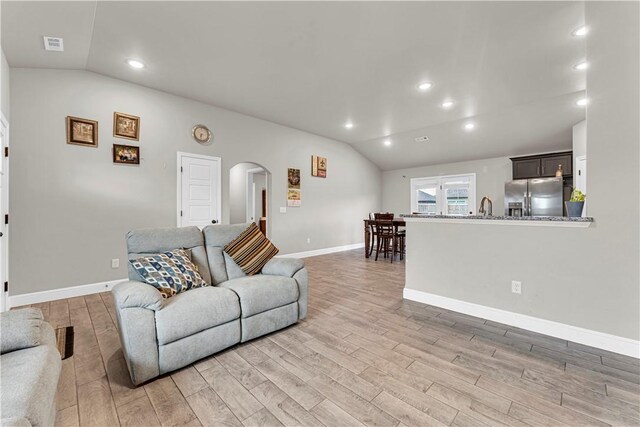200 Post Oak Ave, Gentry, AR 72734 - living area featuring vaulted ceiling, arched walkways, light wood-type flooring, baseboards, and recessed lighting
