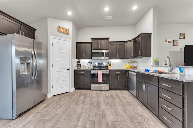 200 Post Oak Ave, Gentry, AR 72734 - kitchen featuring stainless steel appliances, dark brown cabinetry, light wood-type flooring, light stone countertops, and recessed lighting