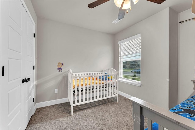 200 Post Oak Ave, Gentry, AR 72734 - carpeted bedroom featuring baseboards, ceiling fan, and a crib