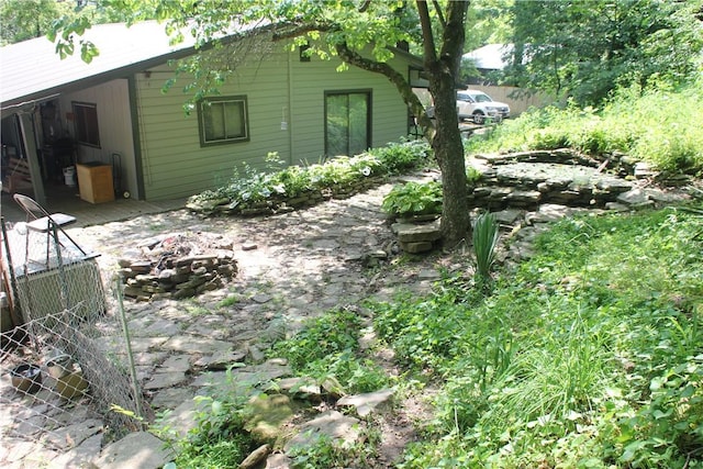 197 7th St, Saint Paul, AR 72756 - view of side of home with an outdoor fire pit