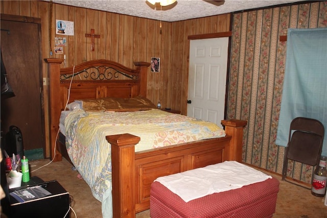 197 7th St, Saint Paul, AR 72756 - carpeted bedroom with wooden walls, a ceiling fan, and a textured ceiling