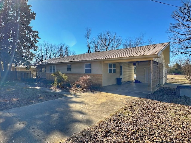 102 Pecan St, Marshall, AR 72650 - view of front of home featuring driveway, an attached carport, metal roof, and brick siding