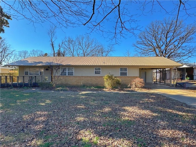 102 Pecan St, Marshall, AR 72650 - view of front facade featuring brick siding, metal roof, a carport, and driveway