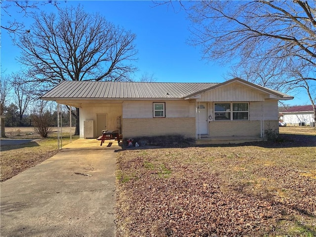 100 Pecan St, Marshall, AR 72650 - single story home featuring brick siding, driveway, metal roof, and an attached carport