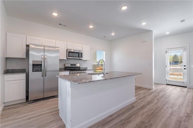 1071 Kentucky Ave, Bentonville, AR 72713 - kitchen featuring stainless steel appliances, a sink, light wood-style floors, baseboards, and white cabinetry