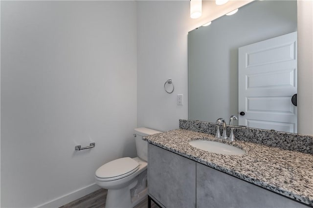 1071 Kentucky Ave, Bentonville, AR 72713 - bathroom with vanity, toilet, wood finished floors, and baseboards