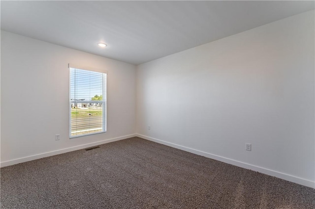 1071 Kentucky Ave, Bentonville, AR 72713 - spare room featuring baseboards, dark carpet, and recessed lighting