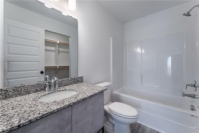 1071 Kentucky Ave, Bentonville, AR 72713 - full bathroom with toilet, vanity, tub / shower combination, and wood finished floors