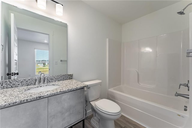1071 Kentucky Ave, Bentonville, AR 72713 - bathroom featuring vanity, toilet, bathtub / shower combination, and wood finished floors