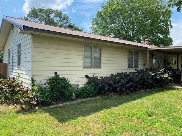 924 W Ave, Lincoln, AR 72744 - view of home's exterior with a yard and metal roof