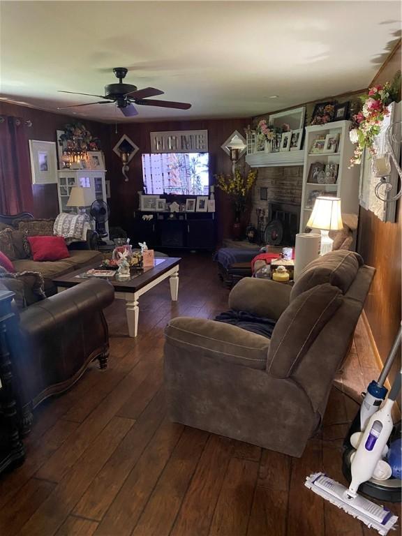 924 W Ave, Lincoln, AR 72744 - living area with wood-type flooring, ceiling fan, and a fireplace