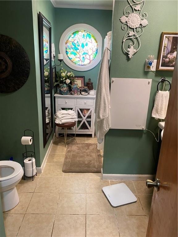 924 W Ave, Lincoln, AR 72744 - bathroom featuring crown molding, tile patterned floors, toilet, and baseboards
