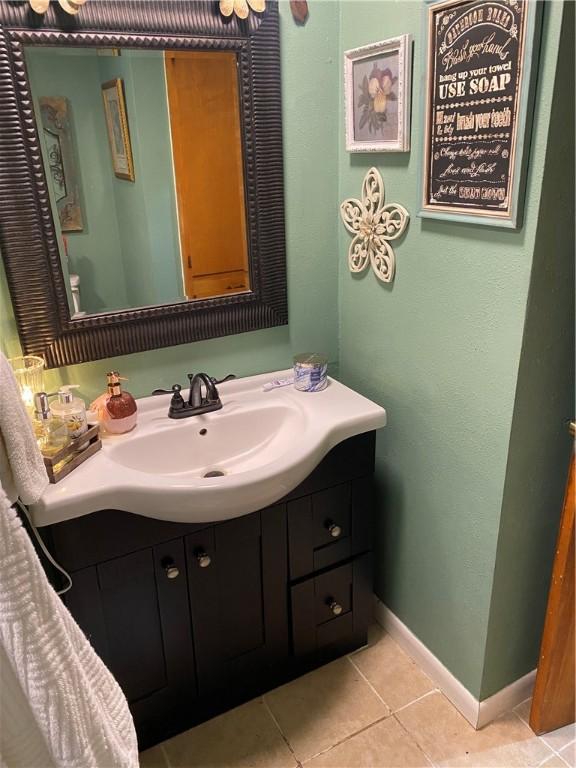 924 W Ave, Lincoln, AR 72744 - bathroom featuring vanity, baseboards, and tile patterned flooring