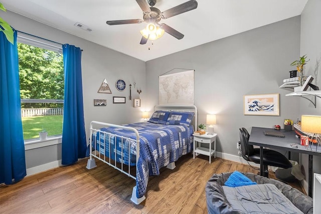 26 Primrose Ln, Bella Vista, AR 72714 - bedroom featuring baseboards, wood finished floors, and a ceiling fan