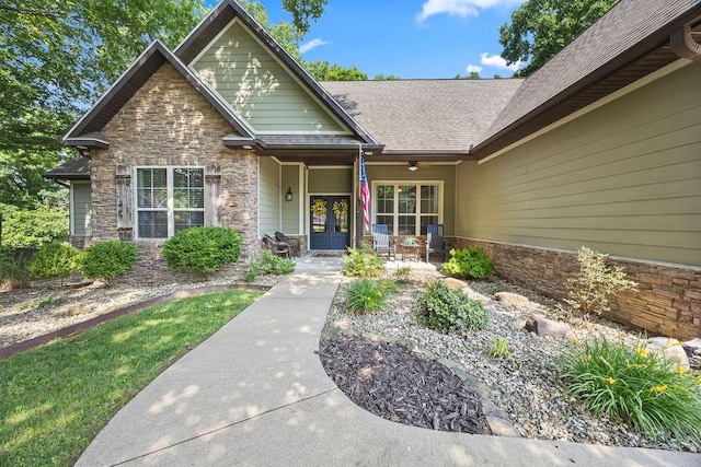 26 Primrose Ln, Bella Vista, AR 72714 - doorway to property with stone siding, french doors, and a shingled roof