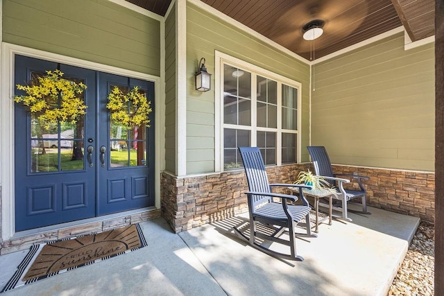 26 Primrose Ln, Bella Vista, AR 72714 - property entrance with stone siding, french doors, and a porch