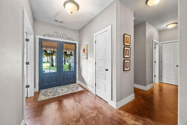 26 Primrose Ln, Bella Vista, AR 72714 - foyer entrance with finished concrete flooring, french doors, and baseboards