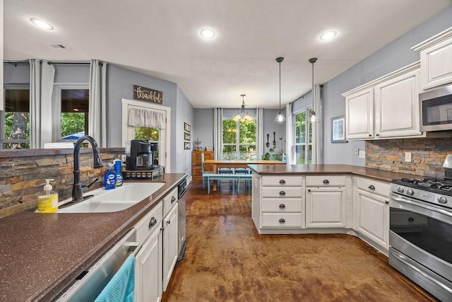 26 Primrose Ln, Bella Vista, AR 72714 - kitchen with appliances with stainless steel finishes, dark countertops, a sink, decorative backsplash, and recessed lighting