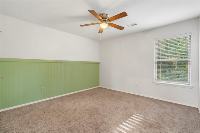 1505 S K Pl, Rogers, AR 72756 - spare room featuring a ceiling fan, carpet floors, and a wainscoted wall