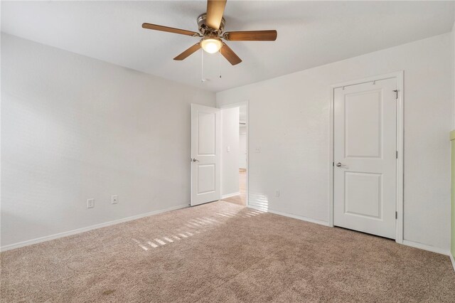 1505 S K Pl, Rogers, AR 72756 - unfurnished bedroom featuring carpet flooring, baseboards, and a ceiling fan