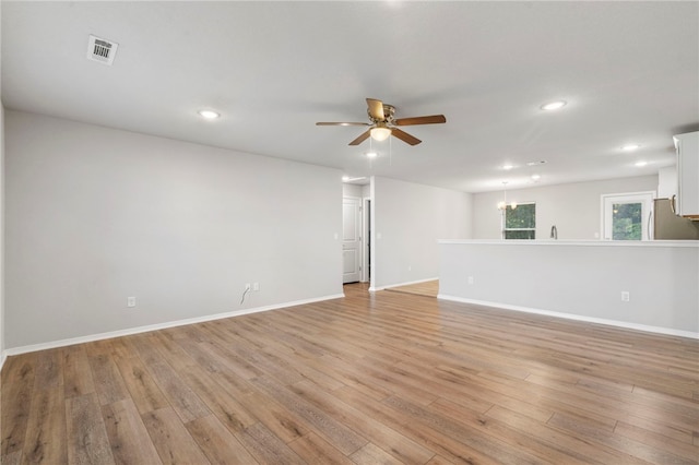 1505 S K Pl, Rogers, AR 72756 - spare room featuring a ceiling fan, light wood-type flooring, recessed lighting, baseboards, and a chandelier