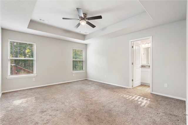 1505 S K Pl, Rogers, AR 72756 - carpeted empty room featuring a raised ceiling, plenty of natural light, a ceiling fan, and baseboards