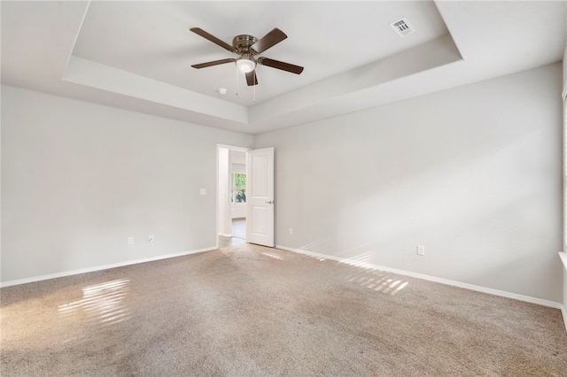1505 S K Pl, Rogers, AR 72756 - carpeted spare room featuring a tray ceiling, ceiling fan, and baseboards