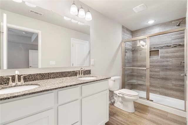 1505 S K Pl, Rogers, AR 72756 - full bathroom with toilet, double vanity, a stall shower, and wood finished floors