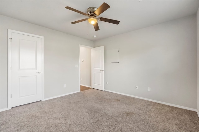 1505 S K Pl, Rogers, AR 72756 - unfurnished bedroom with carpet, baseboards, and a ceiling fan