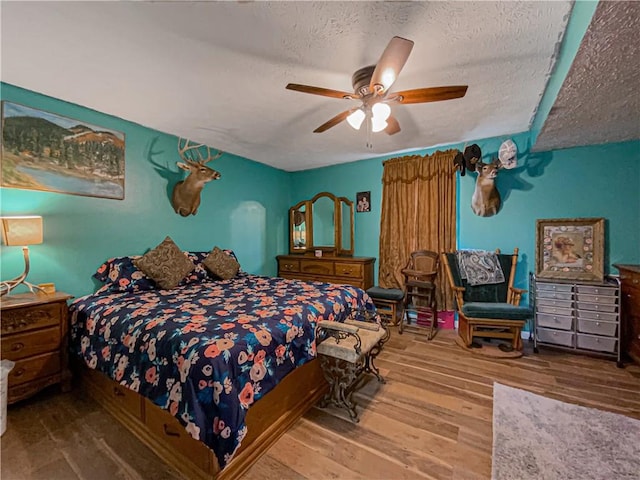 108 Clive St, Berryville, AR 72616 - bedroom featuring wood finished floors, a textured ceiling, and ceiling fan
