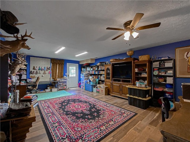 108 Clive St, Berryville, AR 72616 - living room featuring ceiling fan, wood finished floors, and a textured ceiling