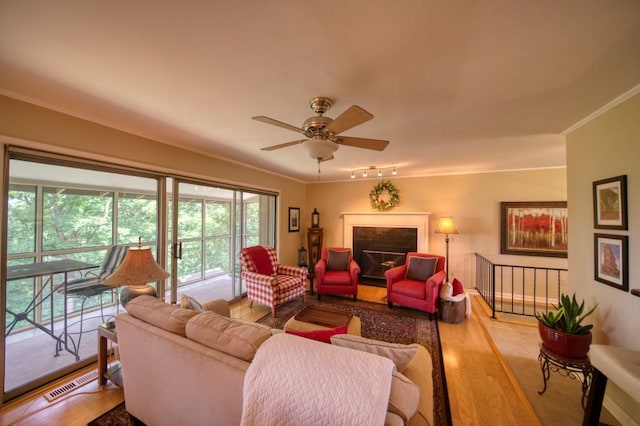 122 Hillcrest Rd, Eureka Springs, AR 72631 - living room with crown molding, wood finished floors, a ceiling fan, and a fireplace
