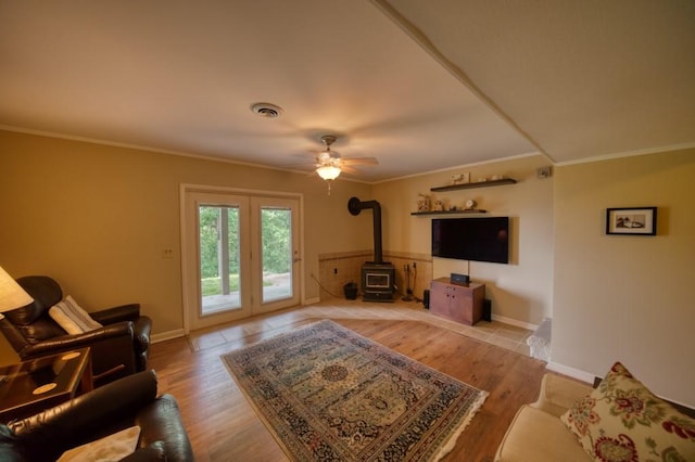 122 Hillcrest Rd, Eureka Springs, AR 72631 - living area with a wood stove, ornamental molding, baseboards, ceiling fan, and wood finished floors