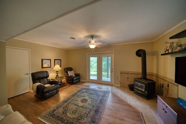 122 Hillcrest Rd, Eureka Springs, AR 72631 - living room with a wood stove, light wood-type flooring, ornamental molding, and ceiling fan