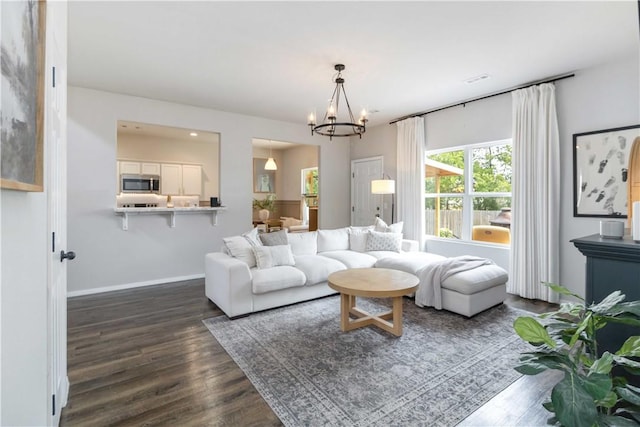 501 W Pittsfield, Siloam Springs, AR 72761 - living room with dark wood-style floors, a chandelier, and baseboards
