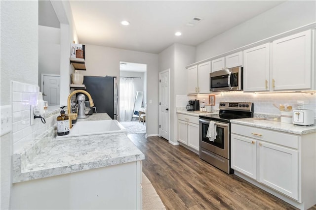 501 W Pittsfield, Siloam Springs, AR 72761 - kitchen with appliances with stainless steel finishes, a sink, tasteful backsplash, white cabinetry, and dark wood-style floors