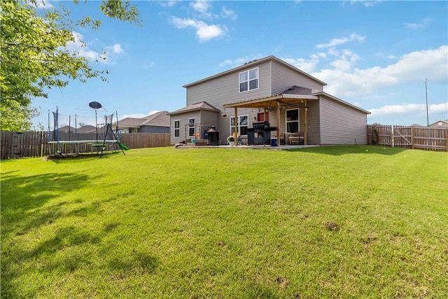 501 W Pittsfield, Siloam Springs, AR 72761 - back of property featuring a trampoline and a patio