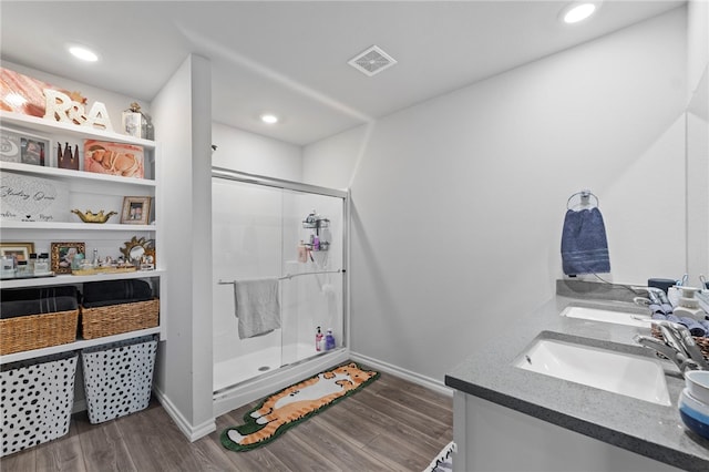 615 W Dusty Ct, Siloam Springs, AR 72761 - bathroom with a stall shower, double vanity, wood finished floors, baseboards, and recessed lighting