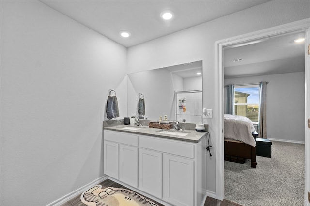 615 W Dusty Ct, Siloam Springs, AR 72761 - ensuite bathroom featuring double vanity, baseboards, and recessed lighting