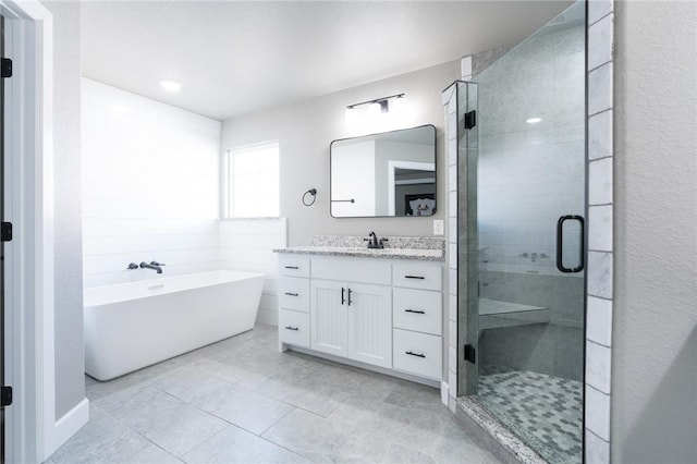 1909 Crump St, Pea Ridge, AR 72751 - full bath with a freestanding bath, a shower stall, vanity, and tile patterned flooring