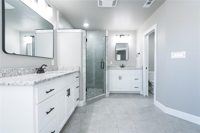 1909 Crump St, Pea Ridge, AR 72751 - full bathroom featuring a shower stall, baseboards, toilet, two vanities, and tile patterned floors